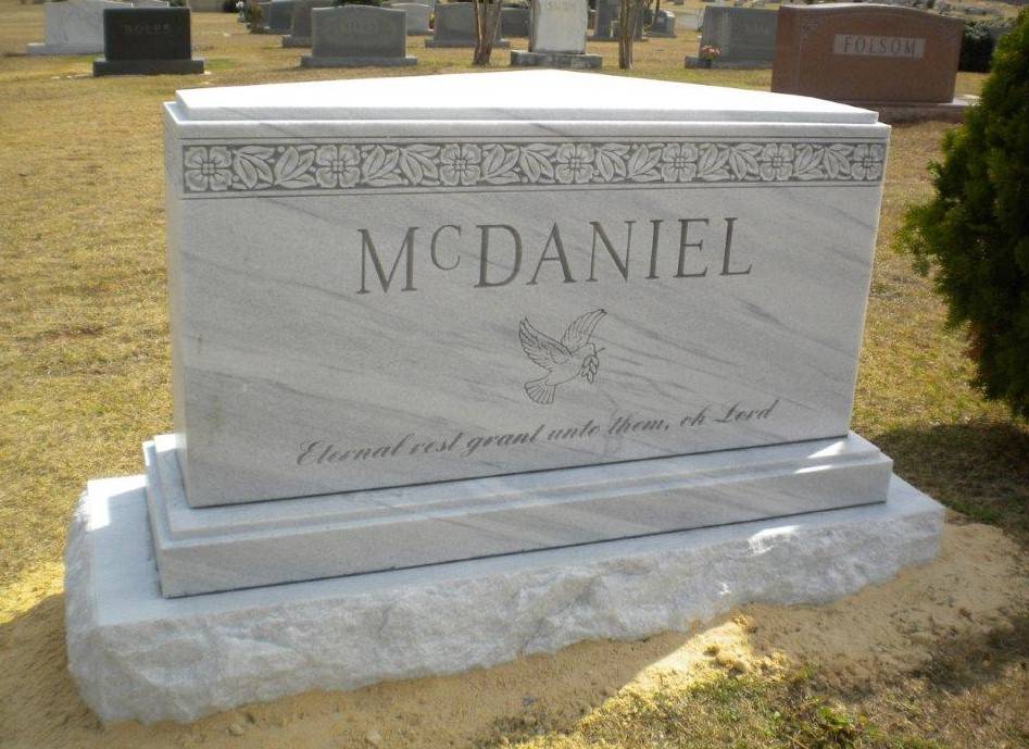 A memorial slab for Mcdaniel with a dove illustration
