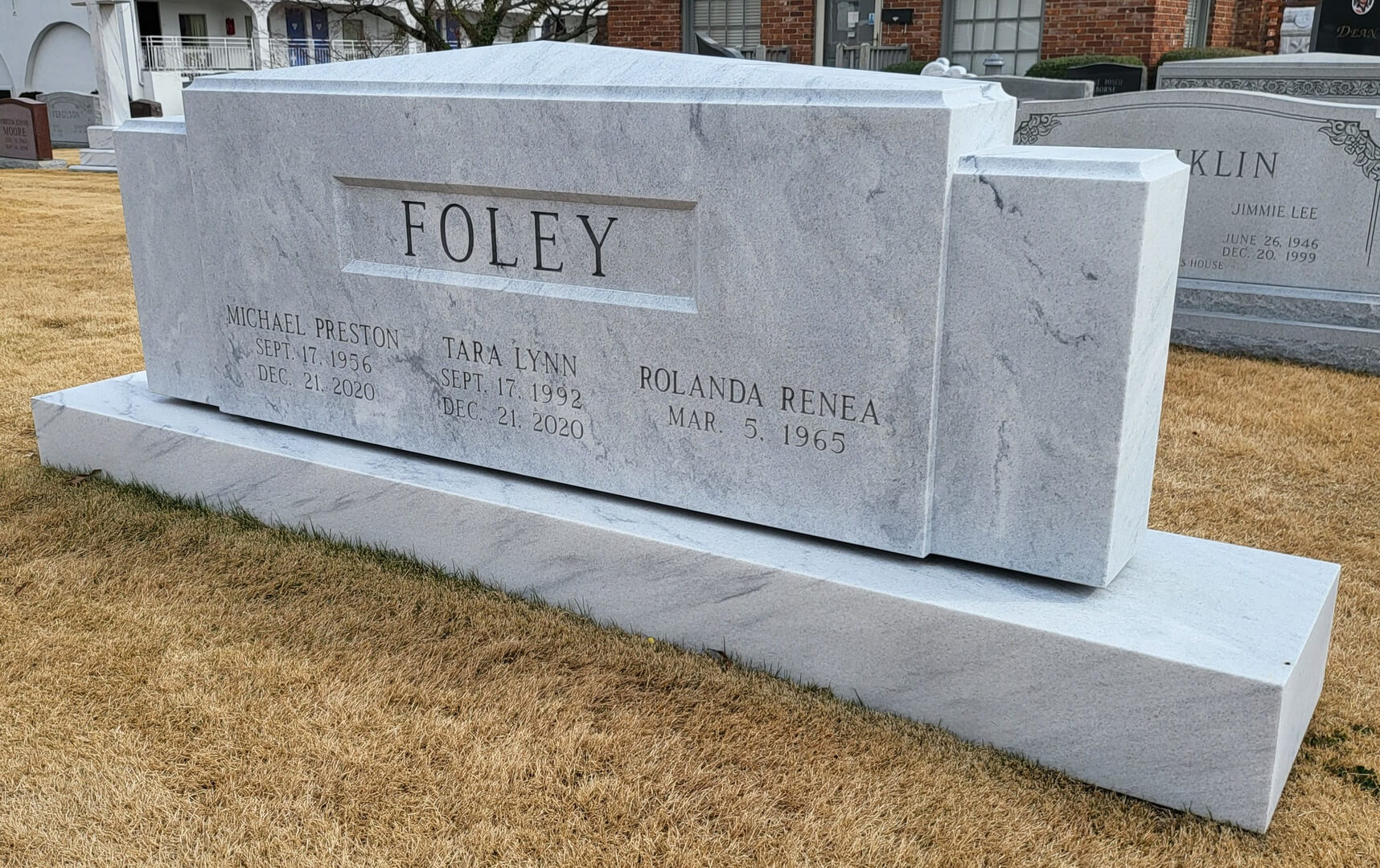 A memorial slab with the name and illustration by the text Foley