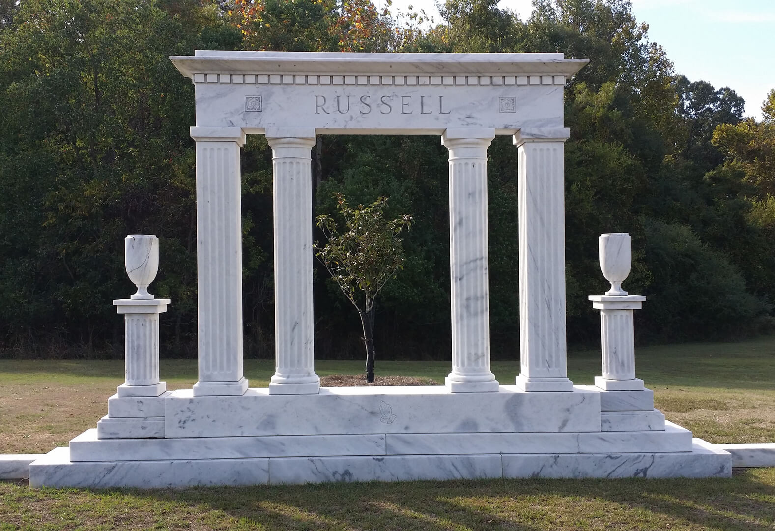 A unique shaped mausoleum with the name Russel