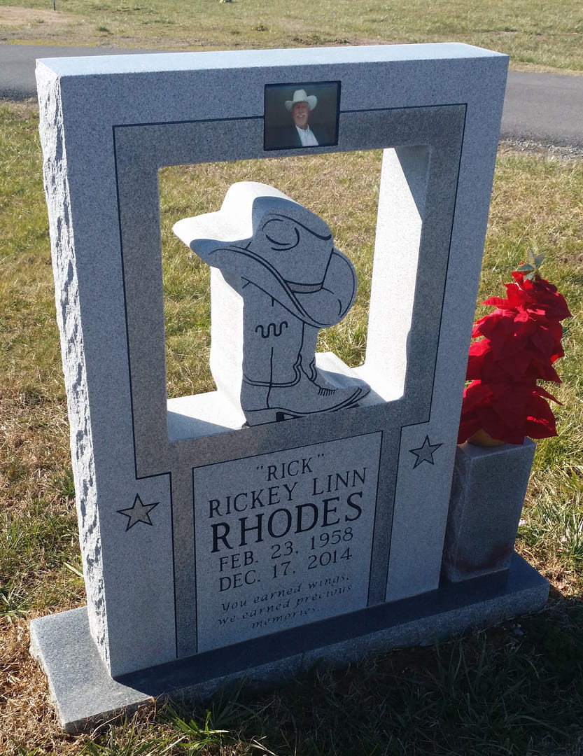 A Memorial Block With Cow Boy Hat and Boot With Portrait