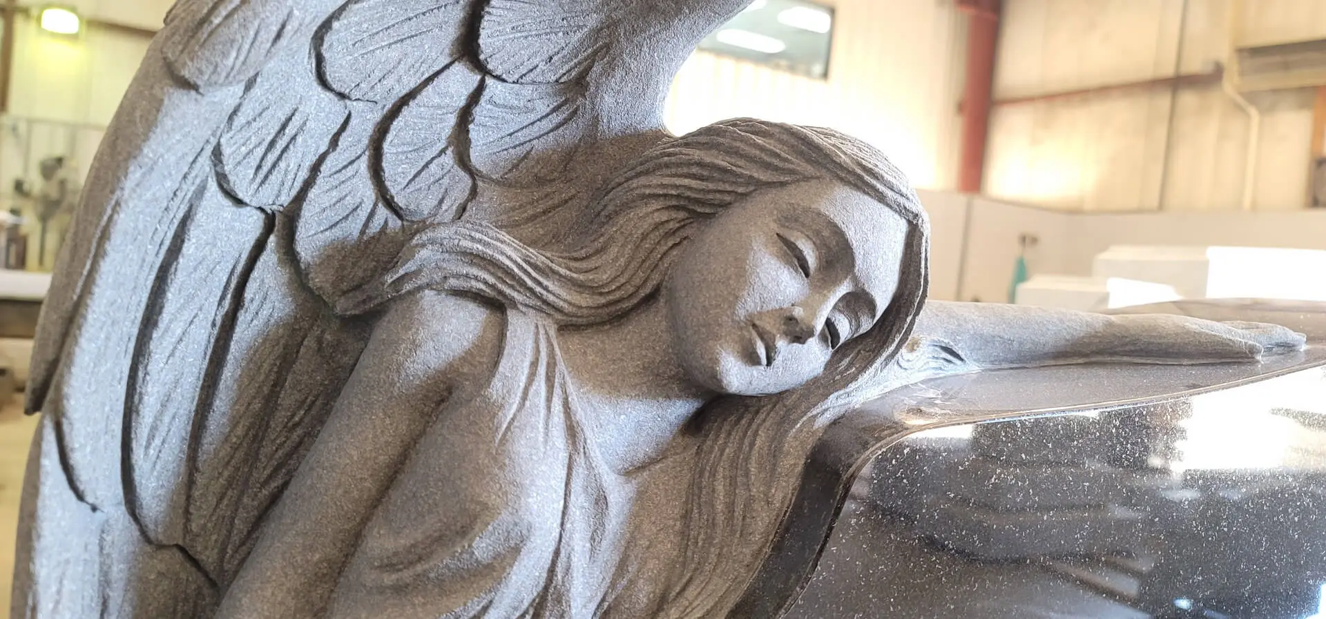 A beautiful statue of an angel with wings lying on the ground
