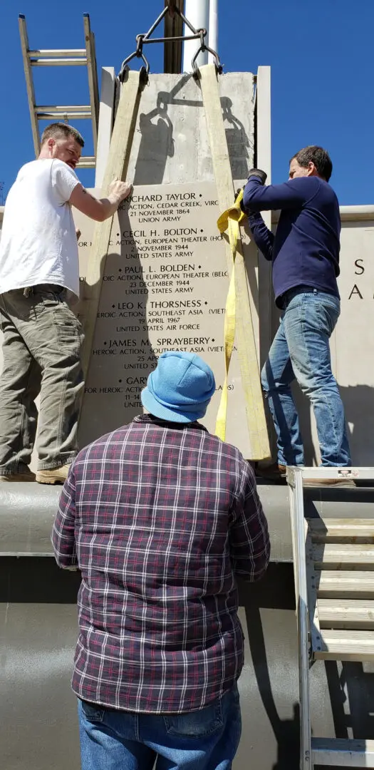Three Men Fixing a Memorial Slab