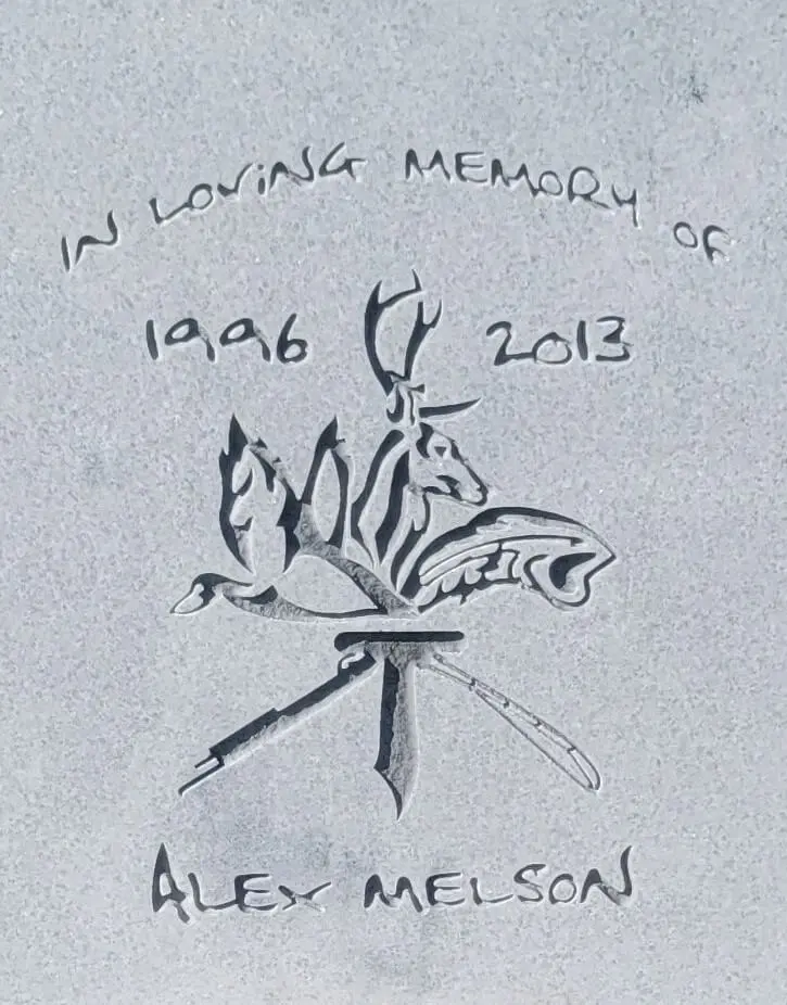 A memorial slab with the name Alex Melson