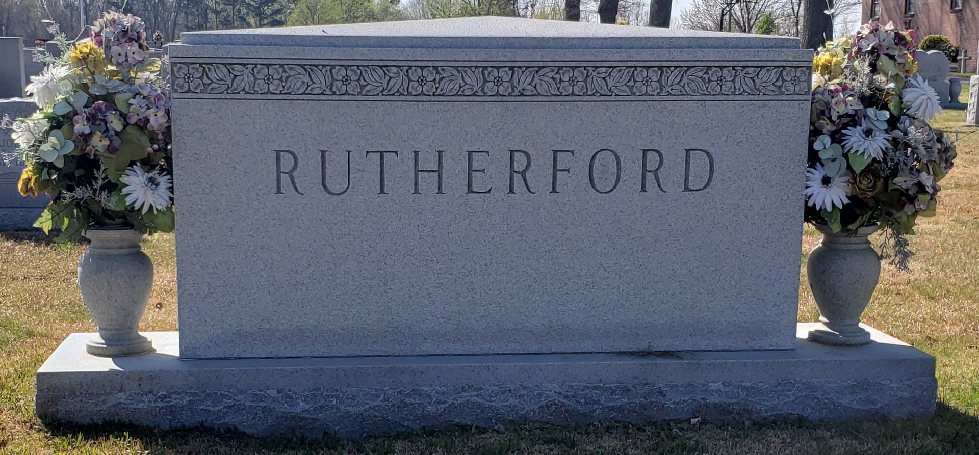 A memorial slab with the name and illustration by the text Rutherford