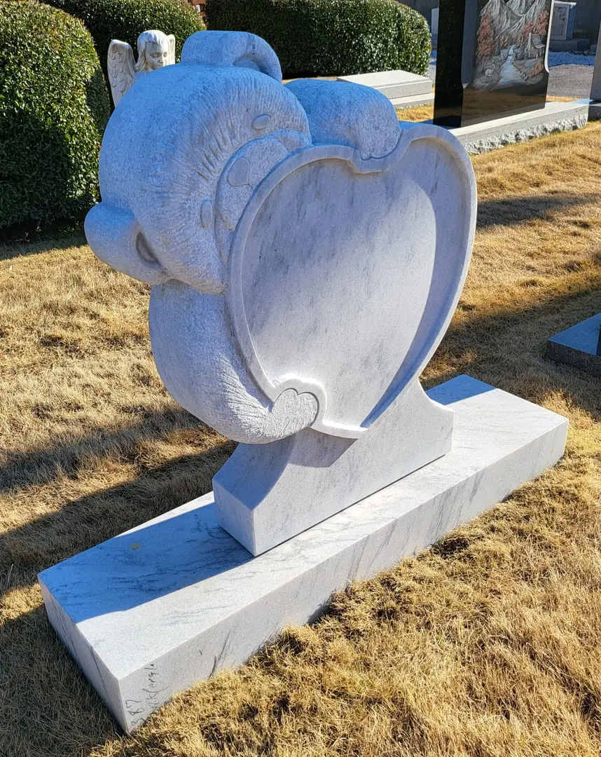 A White Teddy Holding Heart Statue Memorial Block