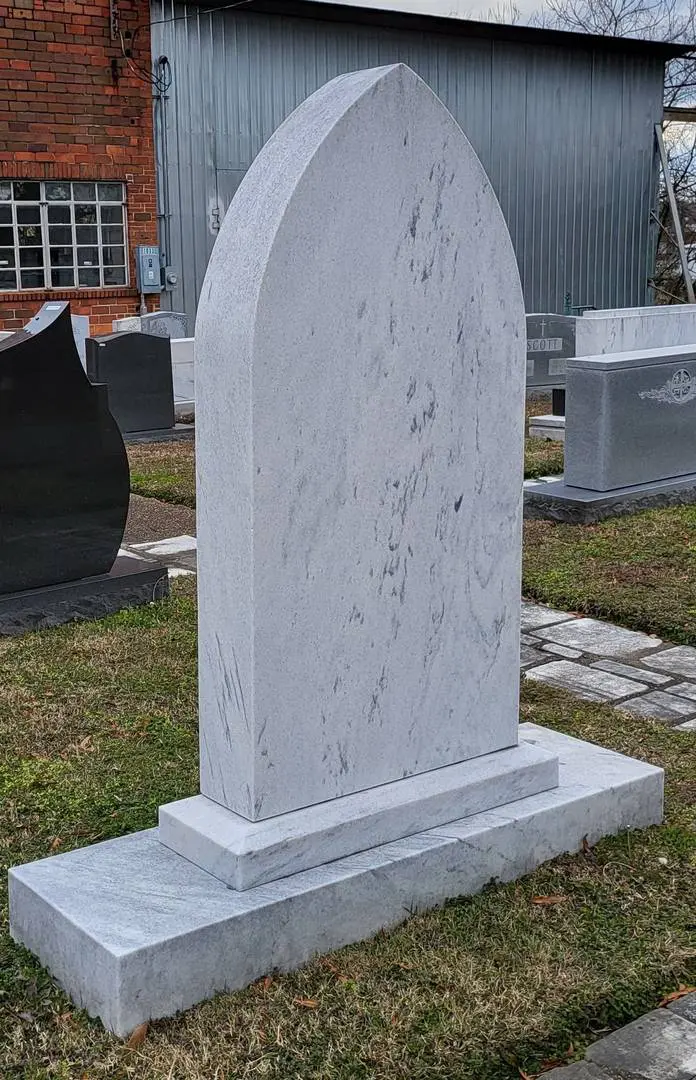 An empty tombstone with unique shape and design