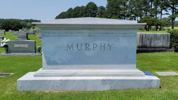 A memorial slab with the name and illustration by the text Murphy