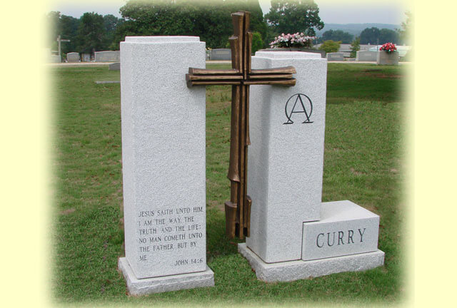 A cross shaped memorial slab with the name Curry and a quote from the Bible
