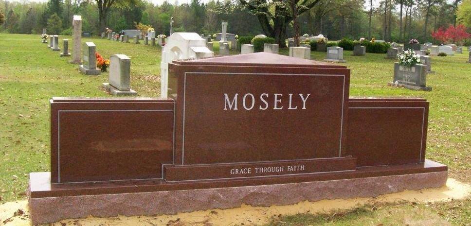A memorial slab with the name Mosely and Grace through faith written on it