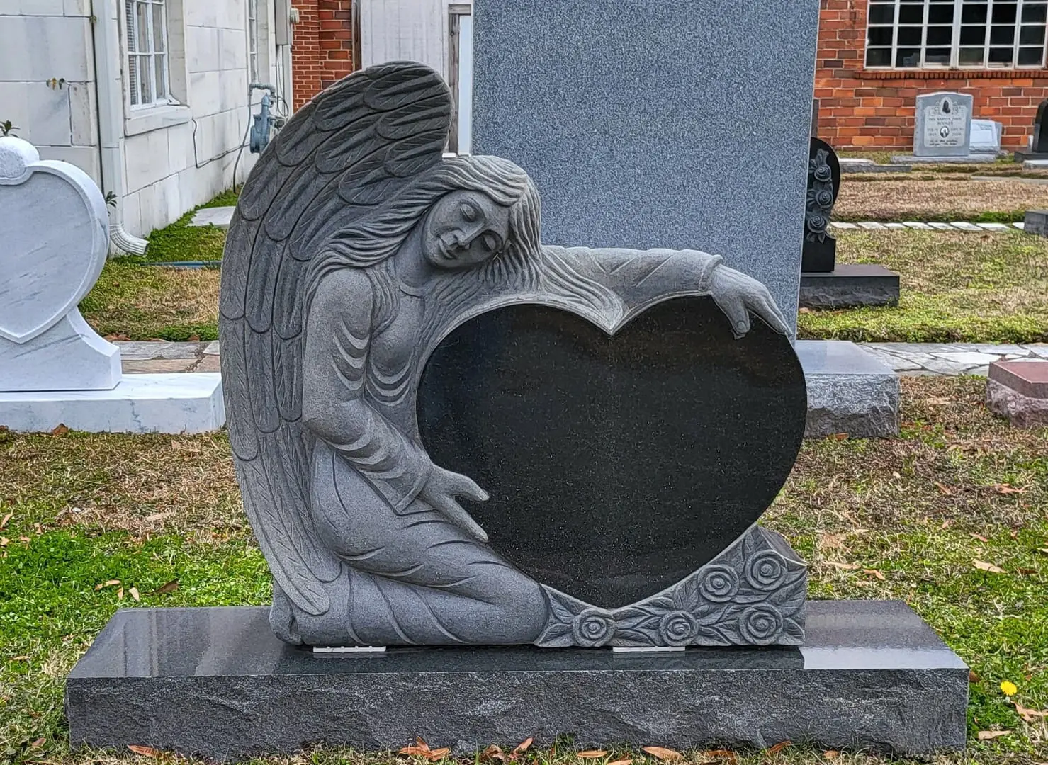 An Angel Holding a Heart Tombstone Block