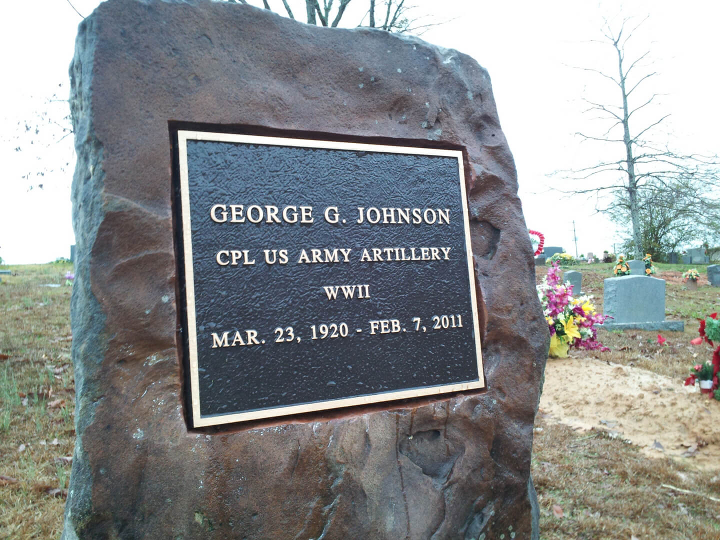 A memorial slab with the name George G. Jhonson