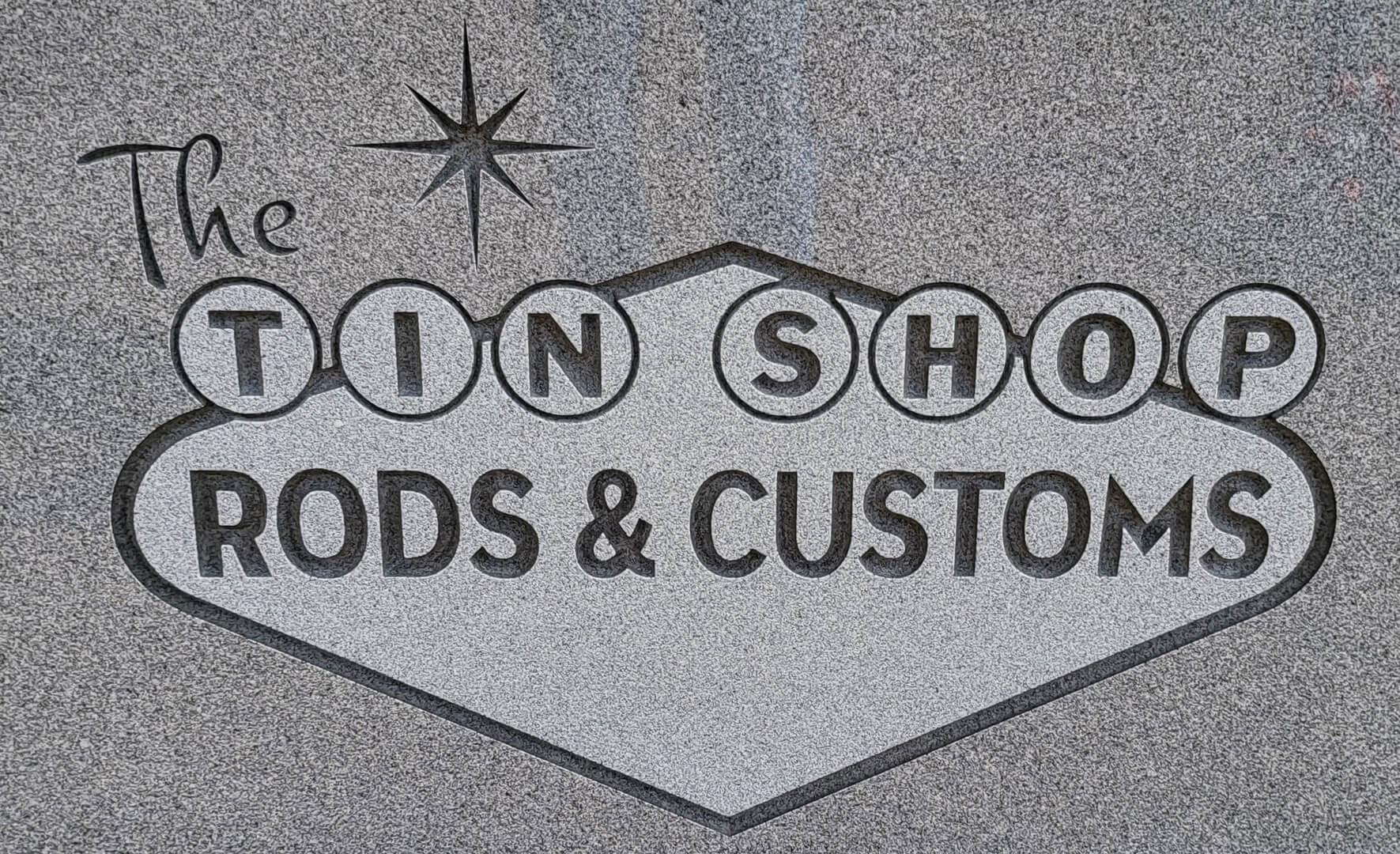A signboard that says The Tin Shop Rods and Customs