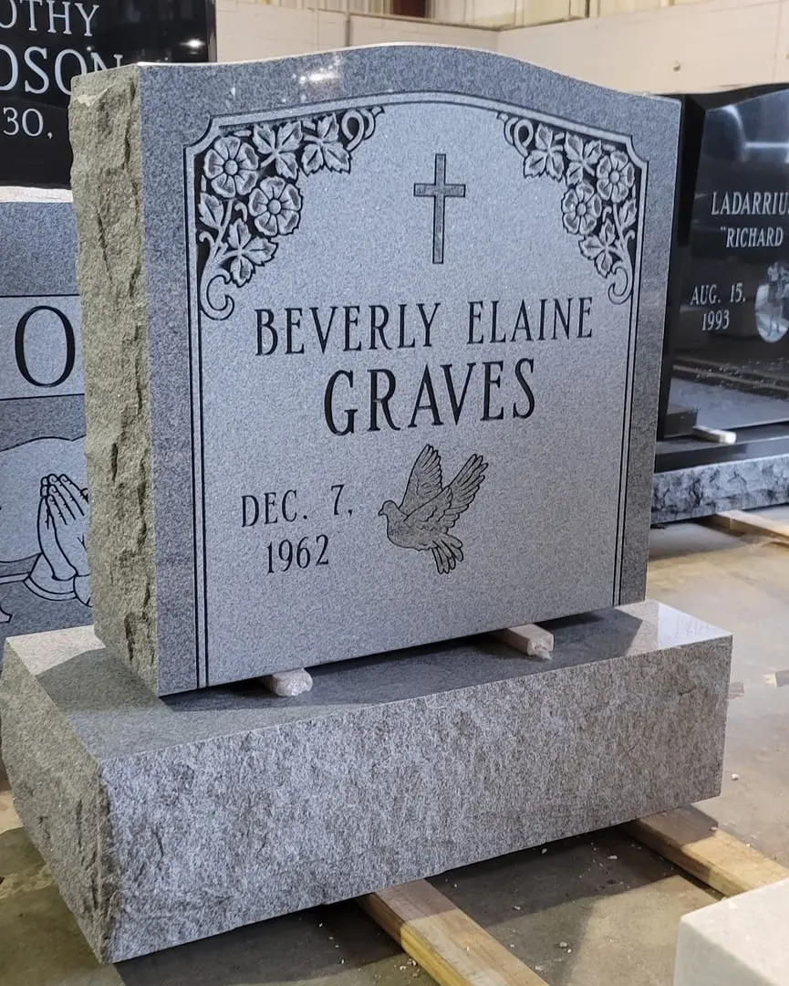 A memorial slab for Beverly Elaine Graves with dove illustration
