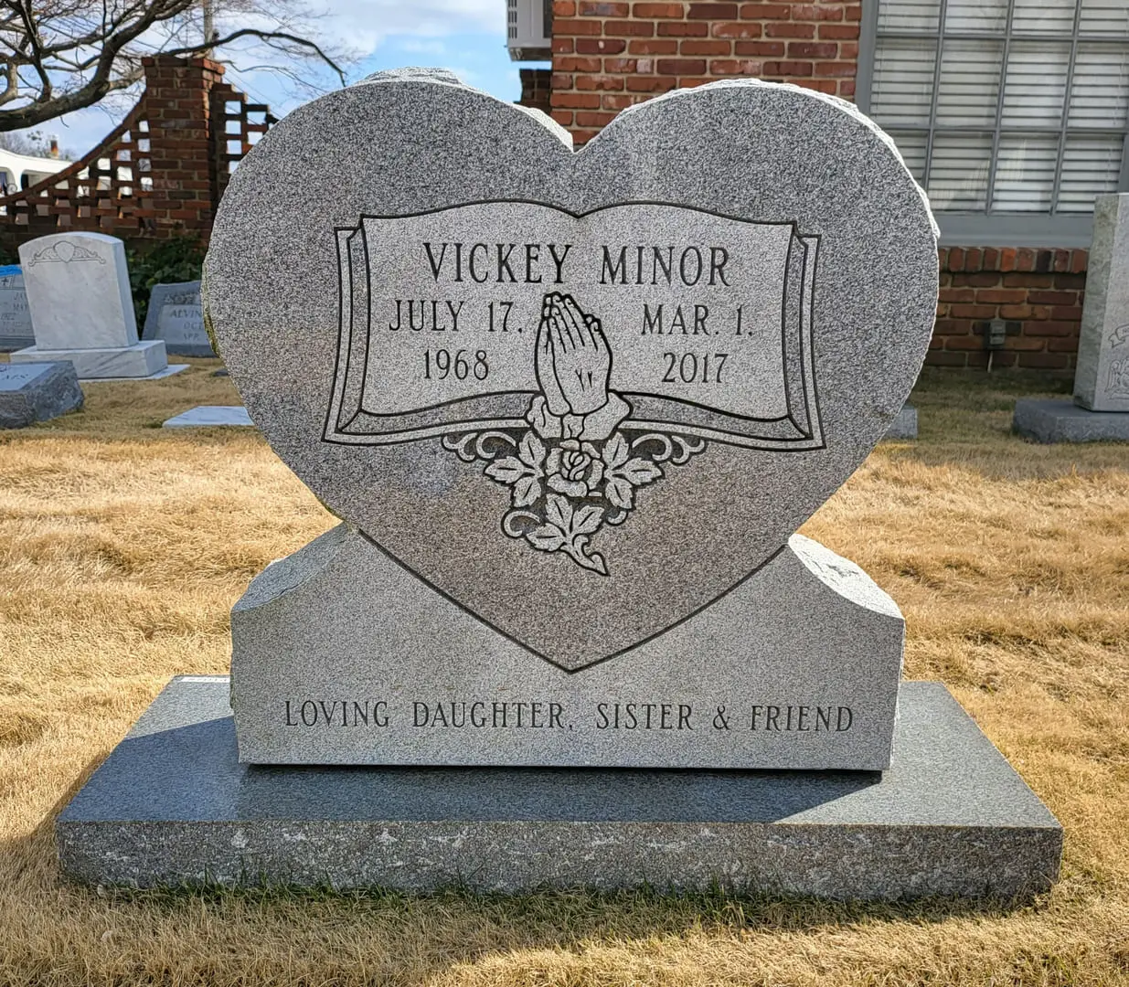 A memorial slab for Vickey Minor with rose illustration