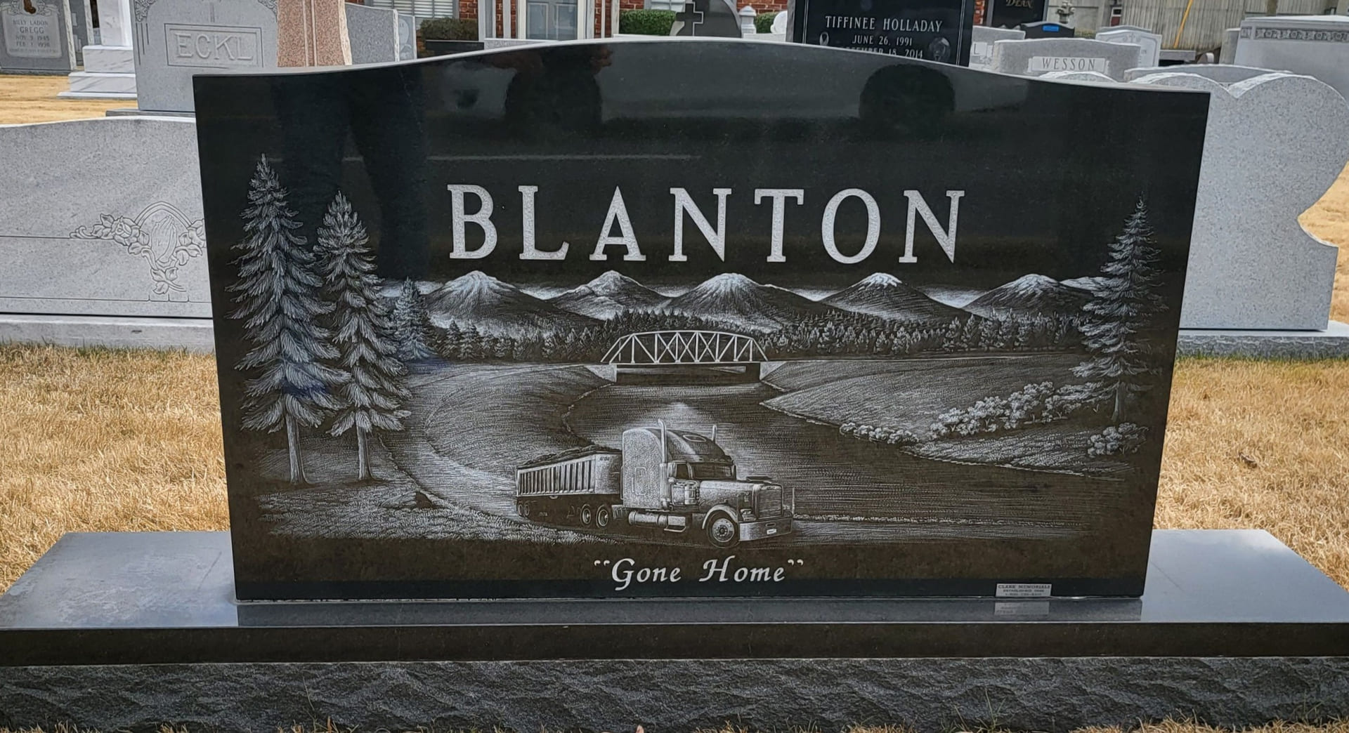 A beautiful memorial slab with Blanton logo and illustration