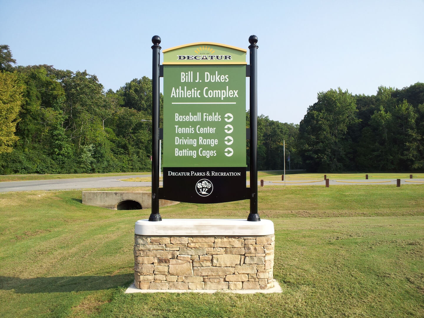 A signboard that says Baseball Fields and Tennis center