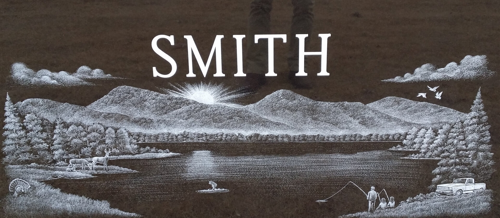 A beautiful piece of artwork with mountains and a name Smith