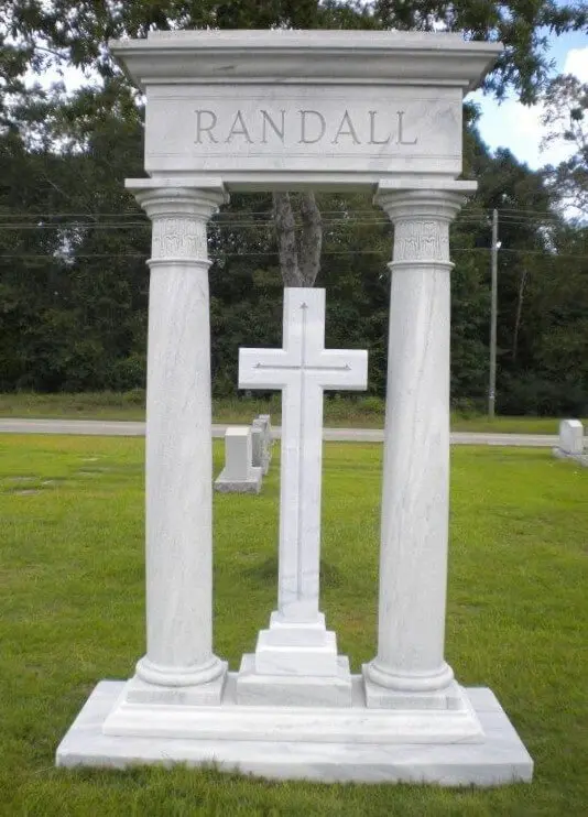 A cross shaped memorial slab with the name Randall