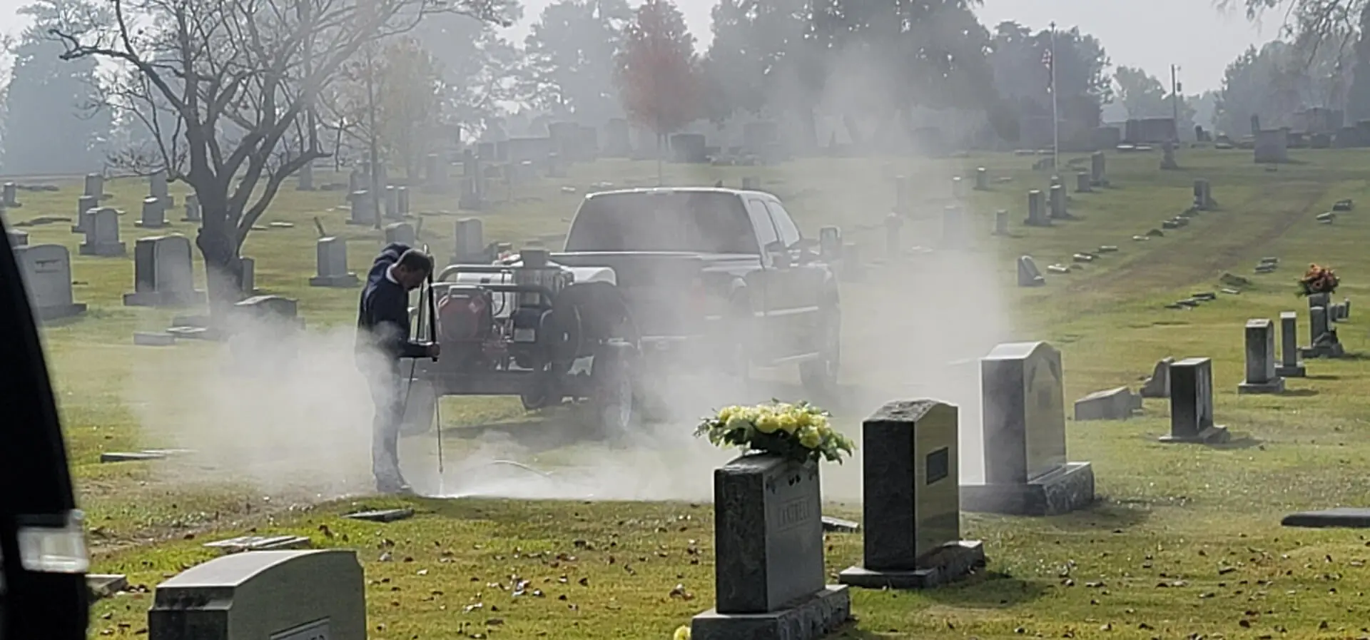 A Cemetery With Smoke and Tombstones