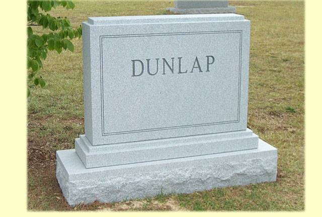 A memorial slab with the name and illustration by the text Dunlap