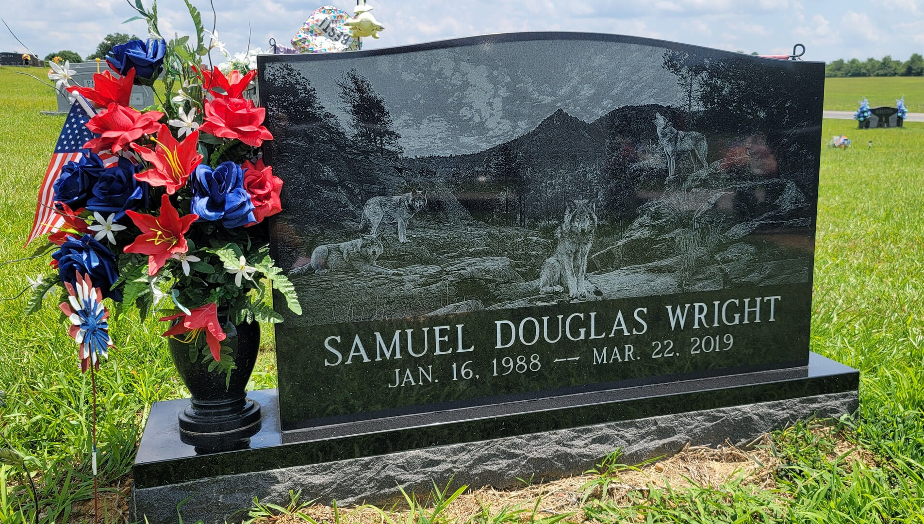A memorial slab for Samuel Douglas Wright with flowers