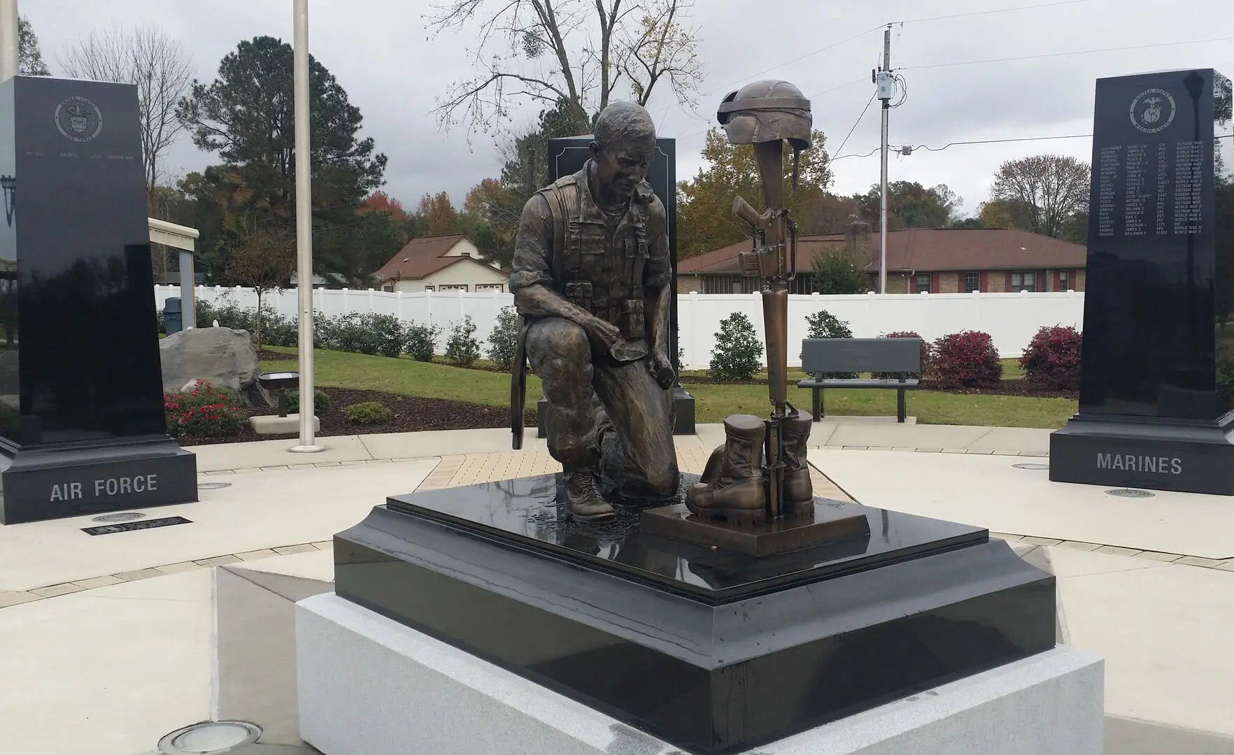 A statue of a war soldier with guns and boots