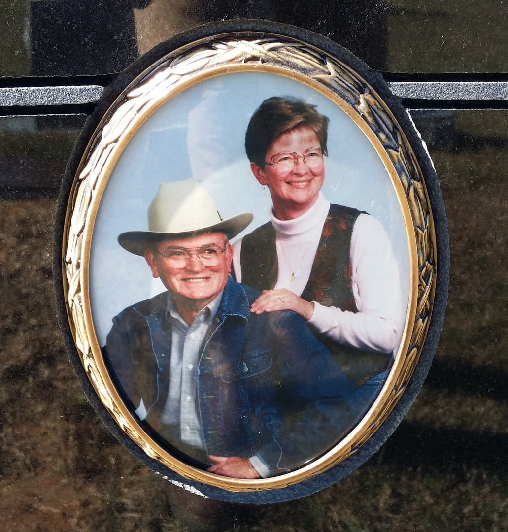 A picture of a couple smiling on a memorial slab
