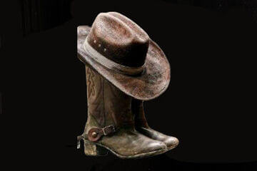 A picture of boots and hats from historic period of time