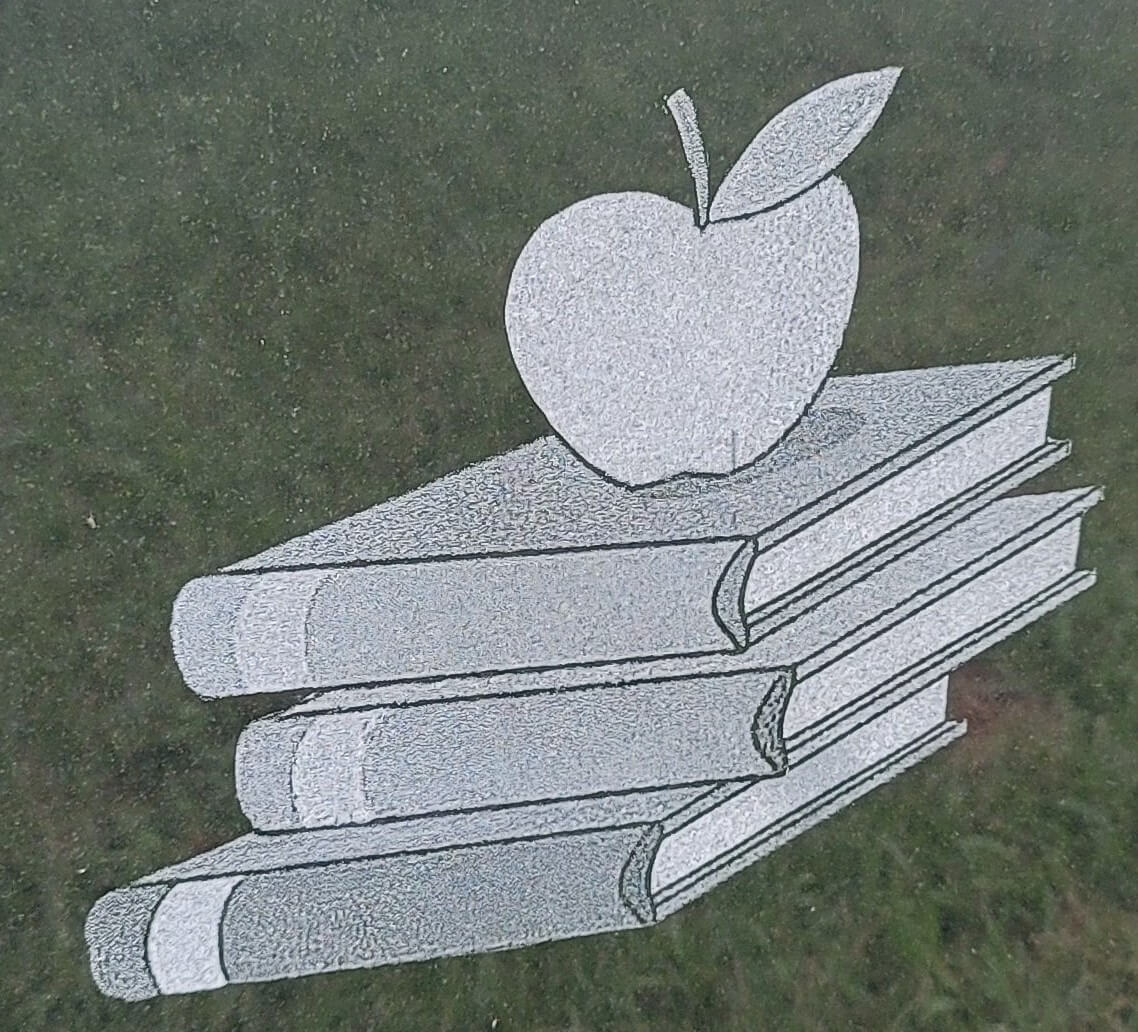 A beautiful piece of artwork of an apple and some books
