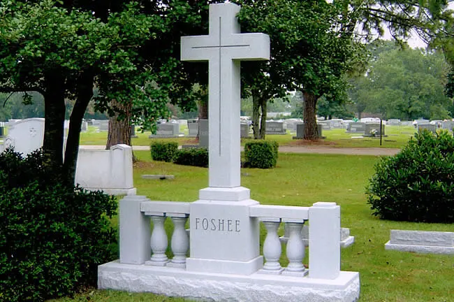 A cross shaped memorial slab with the name Fshee