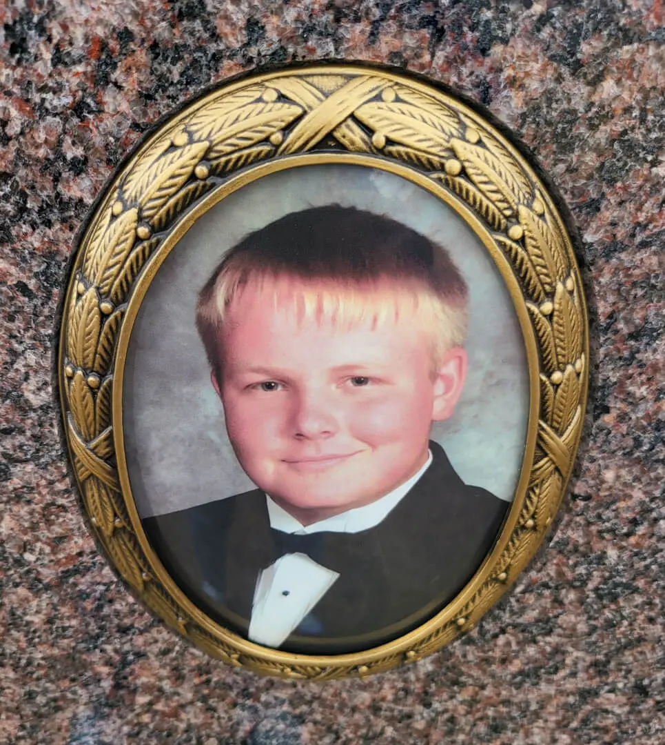 A beautiful picture of a young boy engraved on a memorial slab