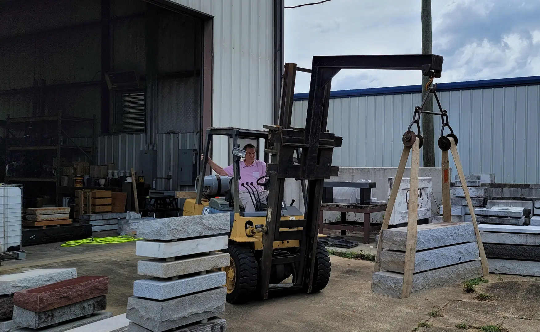 A Forklift Carrying Slabs of Stone from Warehouse
