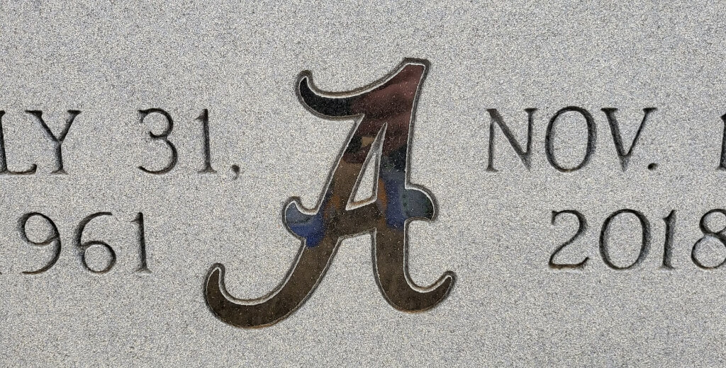 An illustration and logo engraved on a memorial slab