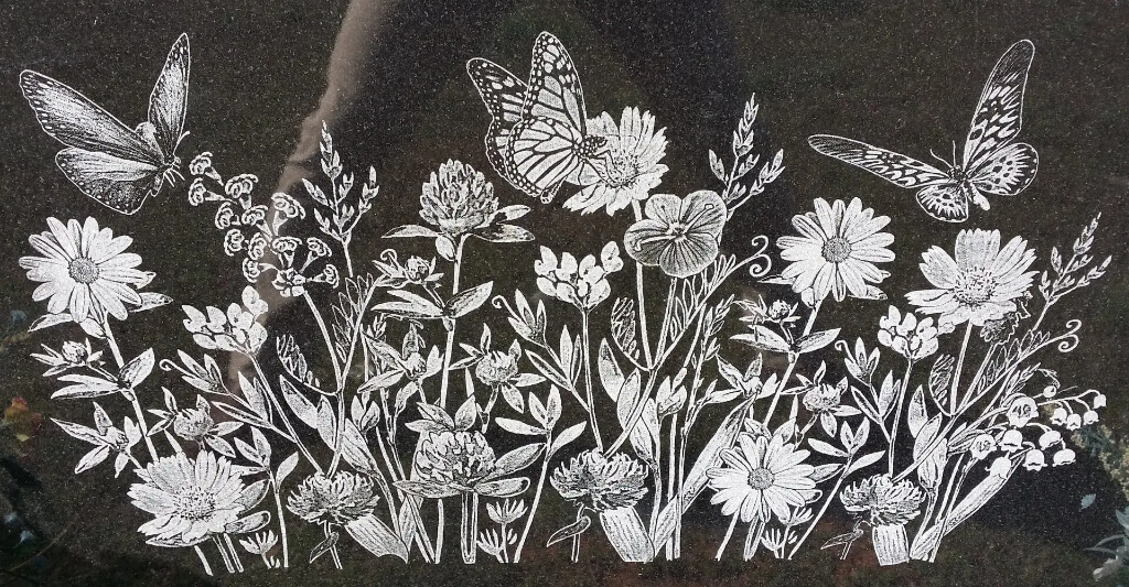 A beautiful piece of artwork with flowers and butterflies