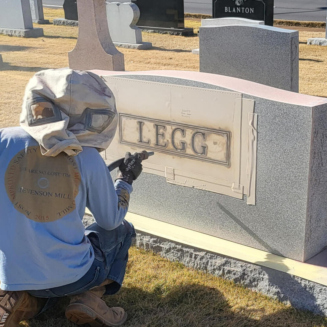 Man is doing Marking work on Marble for loved ones with name